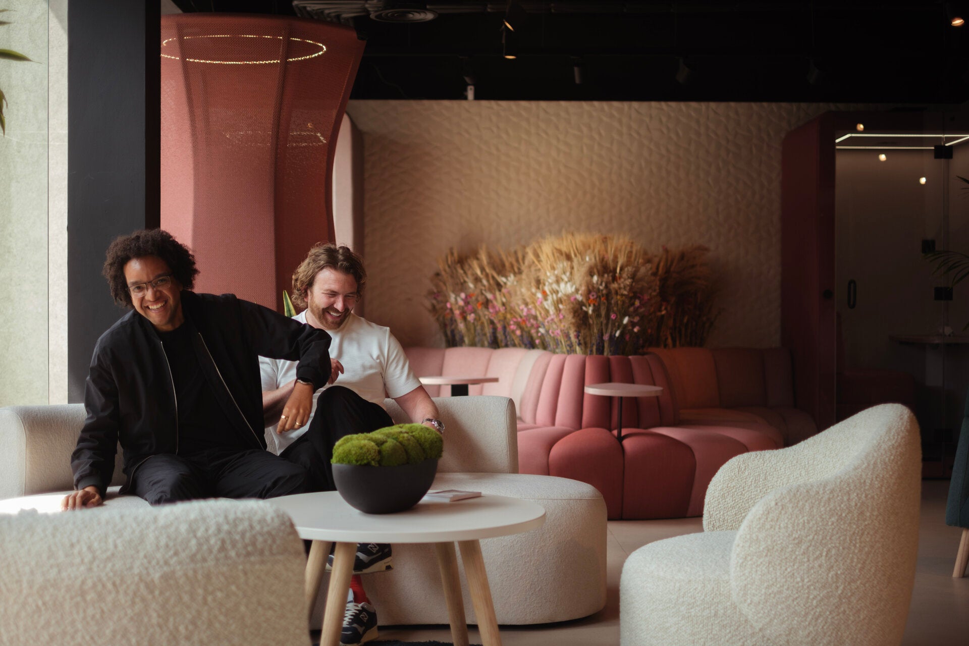 James Mercy and Joe Duffell laughing on Emma sofa