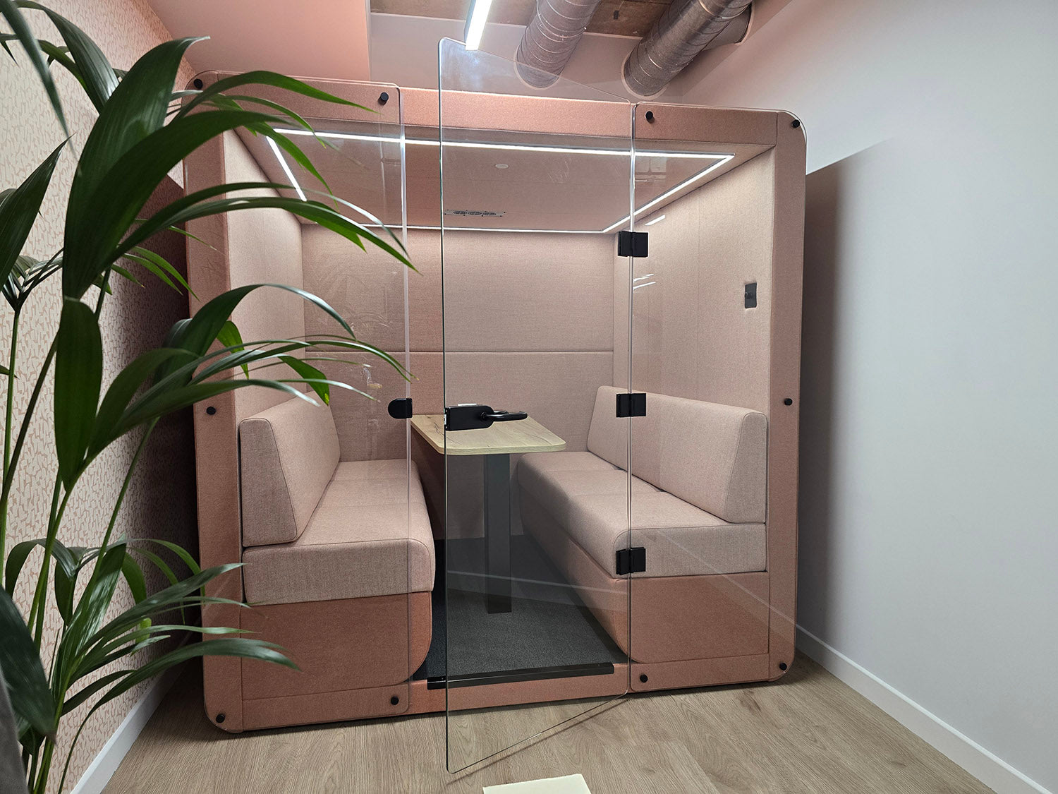 jdd 6 seat bob meeting pod with a glass door and upholstered back wall