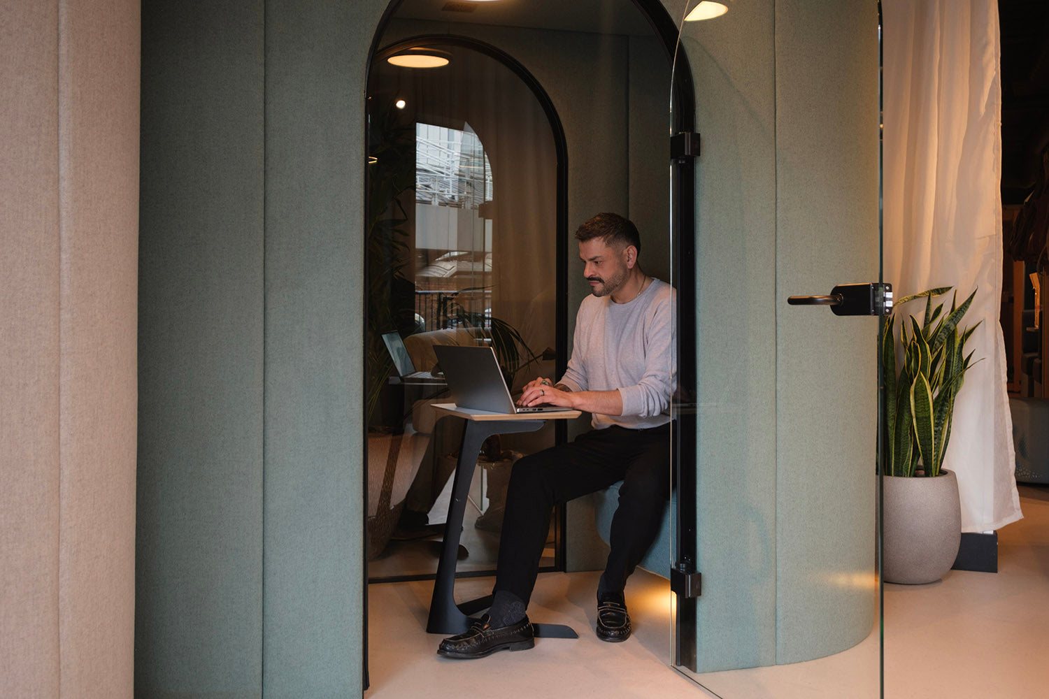 jdd eve wellbeing meeting pod door open with a man using a laptop inside