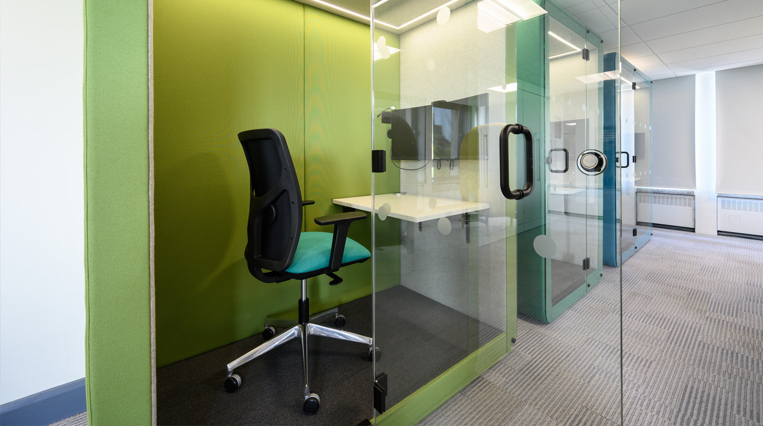 a row of jdd penelope workbooth meeting pods in green and blue