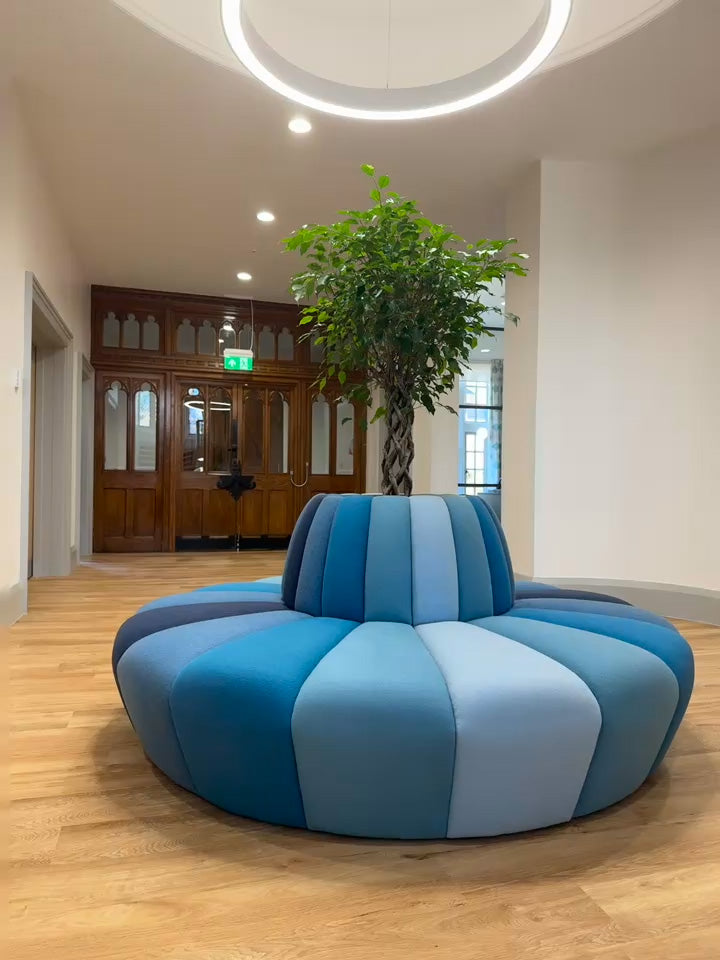 Terry circular banquette seating with tree planter in the middle